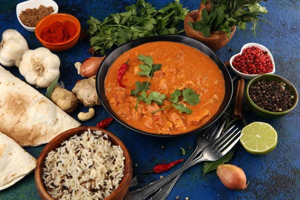 Chicken tikka masala spicy curry meat food in pot with rice and