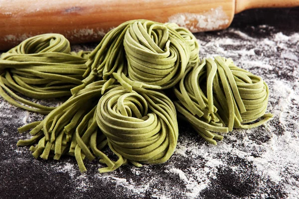 Closeup of raw homemade pasta tagliatelle. fresh italian traditi