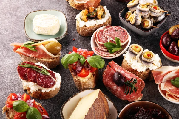 Appetizers table with italian antipasti snacks and wine in glass