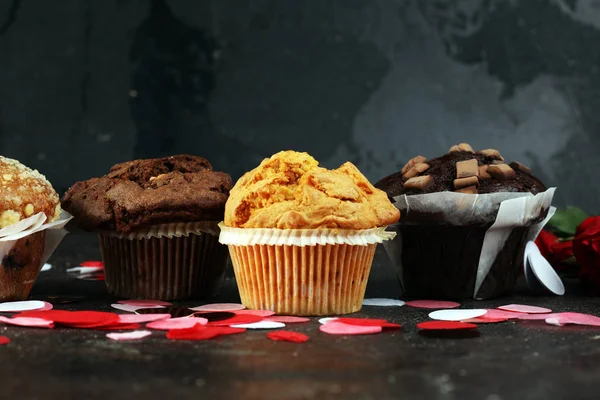 Chocolate muffins, blueberry muffin and nut muffins on dark back — 스톡 사진