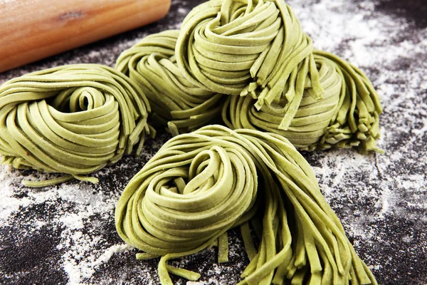 Closeup of raw homemade pasta tagliatelle. fresh italian traditi