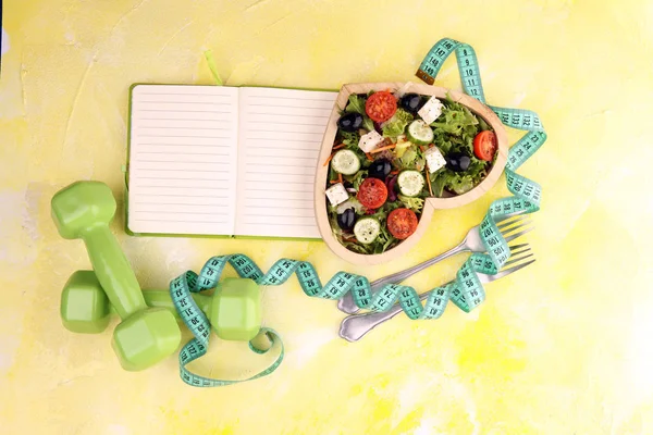 Auténtica ensalada fresca en una taza en forma de corazón de madera con campana de dumbbell. — Foto de Stock