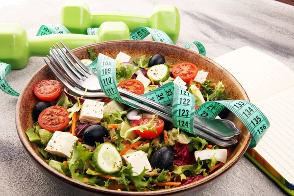 Authentic fresh salad in a stone cup with dumbbells excercise eq — Stock Photo, Image