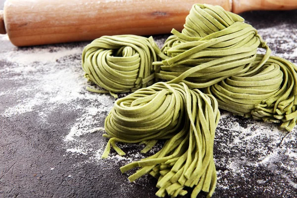 Closeup of raw homemade pasta tagliatelle. fresh italian traditi