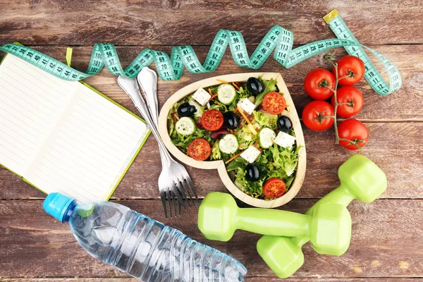 Authentic fresh salad in a wooden heart shaped cup with dumbbell — Stock Photo, Image