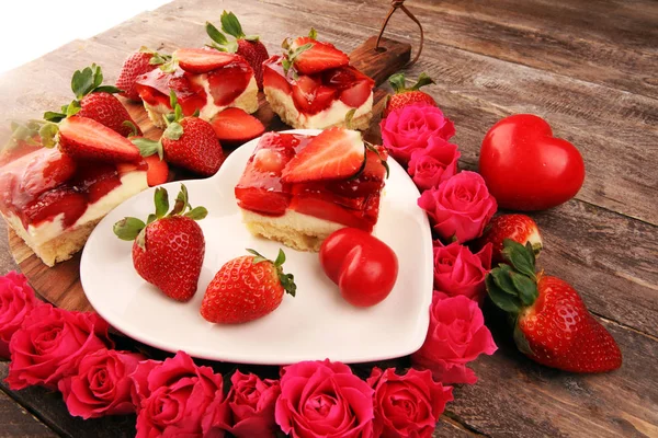 strawberry cake and many fresh strawberries on rustic table with