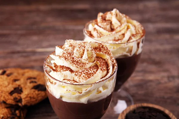 hot chocolate with cocoa and chocolate chip cookies with whipped cream