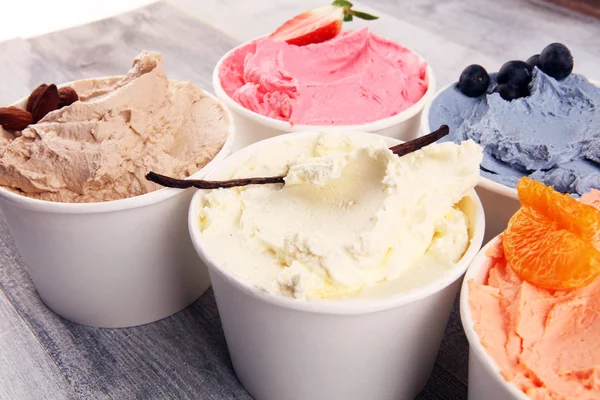 Various of ice cream flavor with fresh blueberry, strawberry, raspberry, chocolate, vanilla setup on rustic background . Summer and Sweet ice cream