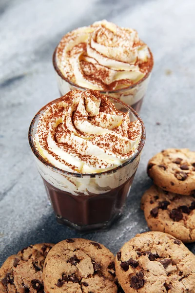 hot chocolate with cocoa and chocolate chip cookies with whipped cream