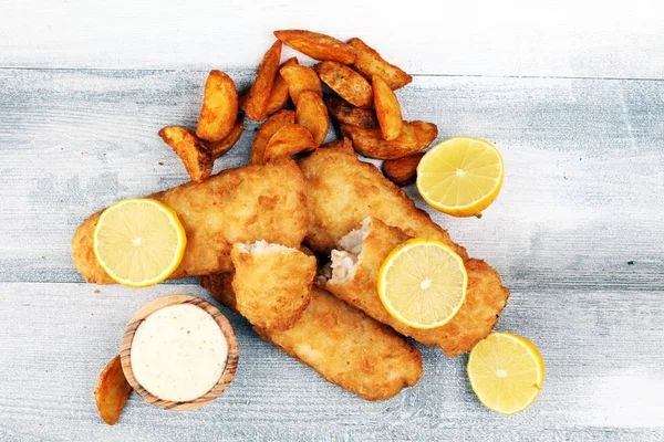 traditional British fish and chips consisting of fried fish, potato chips. fish to takeaway