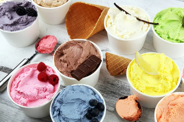 Various of ice cream flavor with fresh blueberry, strawberry, kiwi, lemon, vanilla setup on rustic background . Summer and Sweet ice cream