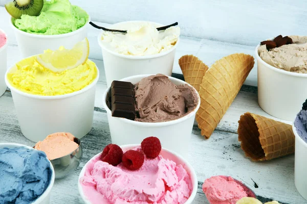 Various of ice cream flavor with fresh blueberry, strawberry, kiwi, lemon, vanilla setup on rustic background . Summer and Sweet ice cream