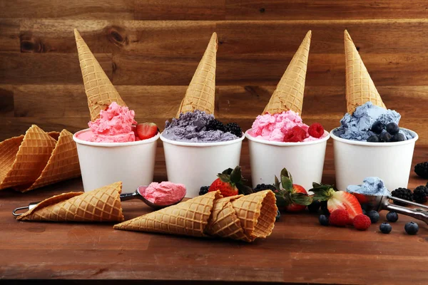 Various of ice cream flavors blueberry, strawberry, blackberry setup on rustic background . Summer and Sweet menu concept. Berries and ice cream