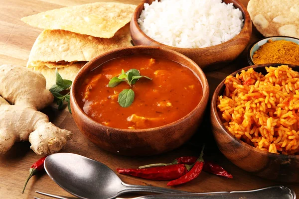 Chicken tikka masala spicy curry meat food in pot with rice and naan bread. indian food with chicken and curry
