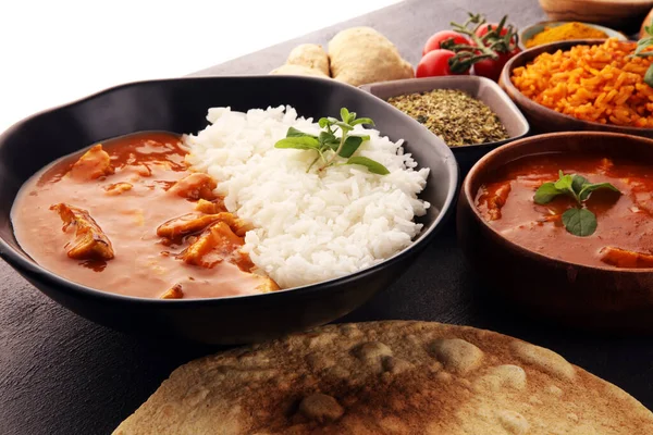 Chicken tikka masala spicy curry meat food in pot with rice and naan bread. indian food with chicken and curry