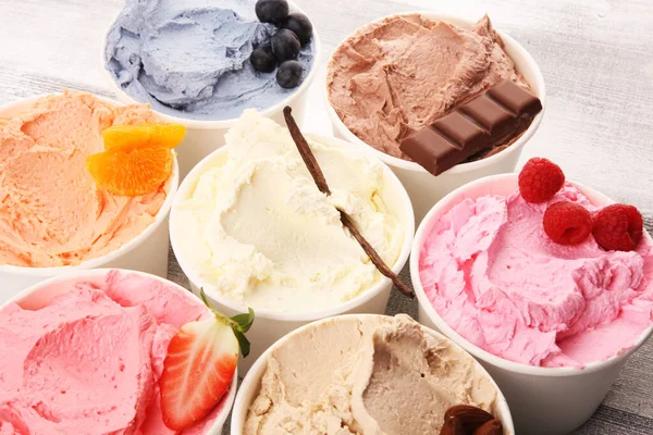 Various of ice cream flavor with fresh blueberry, strawberry, raspberry, chocolate, vanilla setup on rustic background . Summer and Sweet ice cream