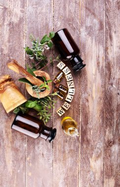 Ev yapımı ve aromatik bitkiler. Mutfak bitkileri. Yeşil yetişen adaçayı, kekik, fesleğen, nane ve kekik. Tahta küplerle sağIık işareti