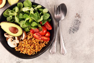 Sağlıklı vejetaryen salata kasesi, kinoa, domates, avokado ve karışık yeşillik, marul. Zencefil ve kinoalı yemek ve sağlık kasesi.