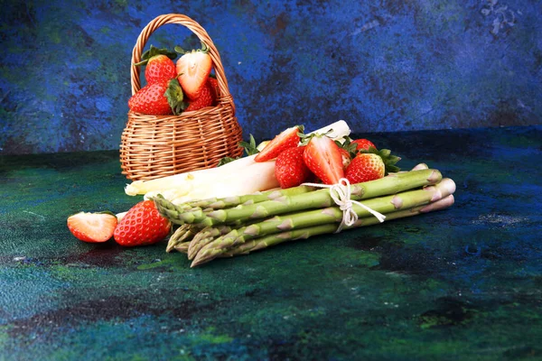 白色和绿色新鲜芦笋与一束健康草莓 — 图库照片