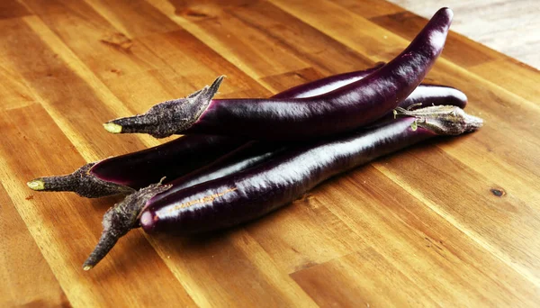 long italian eggplants. variety called perlina. purple healthy vegetable long aubergine on background