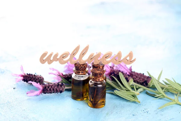 lavender herbal oil and lavender flowers. bottle of lavender massage oil for aromatherapy beauty treatment and wellness letters made of wood