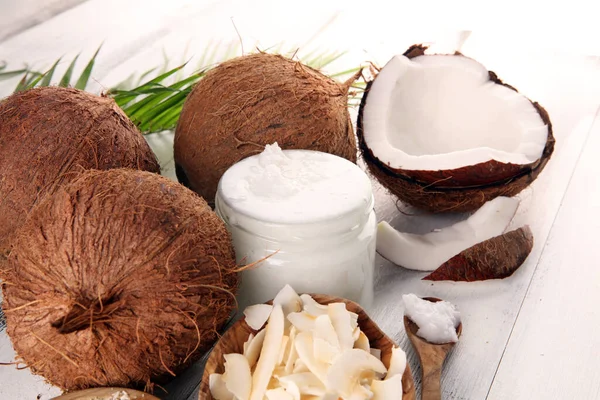 Coconut products with fresh coconut, Coconut flakes, coconut spa oil. Ripe coconut fruits
