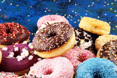 çikolata buzlu, pembe sırlı ve sprinkles donuts ile çeşitli donutlar. şeker ile karnaval kavramı