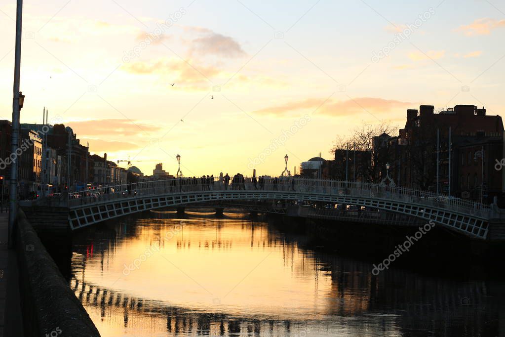 Dublin night scene with Hapenny bridge and Liffey river lights . Ireland
