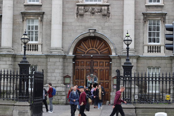 Dublin, Ireland - February 18 2018: People at Trinity College yard in Dublin, Ireland on February 18 2018 this is the largest university in Dublin and all of Ireland.