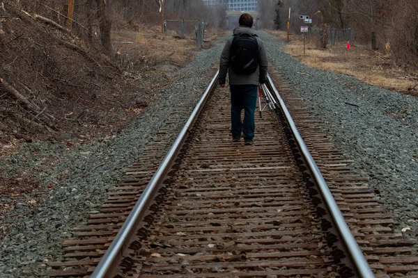 A man walking on the tracks.