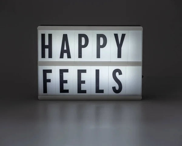 'Happy voelt' in retro lightbox — Stockfoto