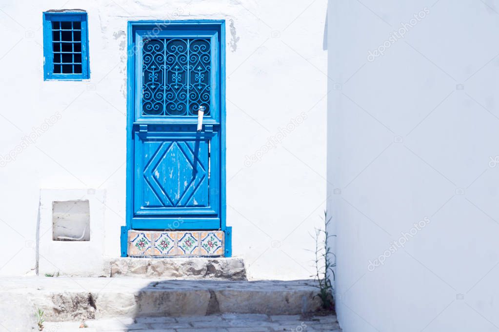 Hot sunny summer day in a blue-and-white Sidi Bou Said city 