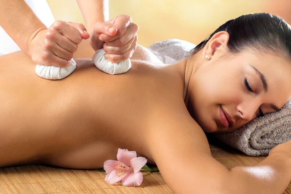 Woman enjoying aromatic pinda massage. — Stock Photo, Image