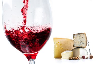 Pouring red wine in glass with cheese clipart