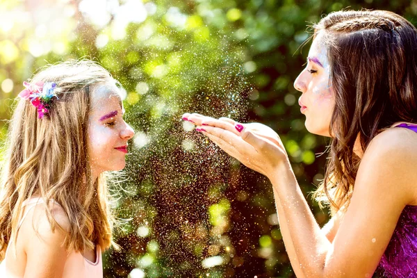 Fairy blowing magic powders to girl. — Stock Photo, Image