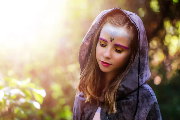 Chica con fantasía maquillaje en el bosque — Foto de Stock