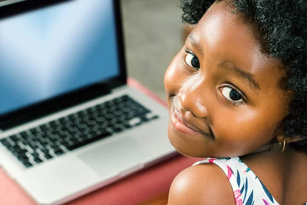 Cute little african girl with laptop — Stock Photo, Image