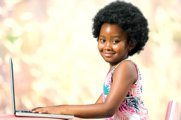 Cute little african girl with laptop — Stock Photo, Image