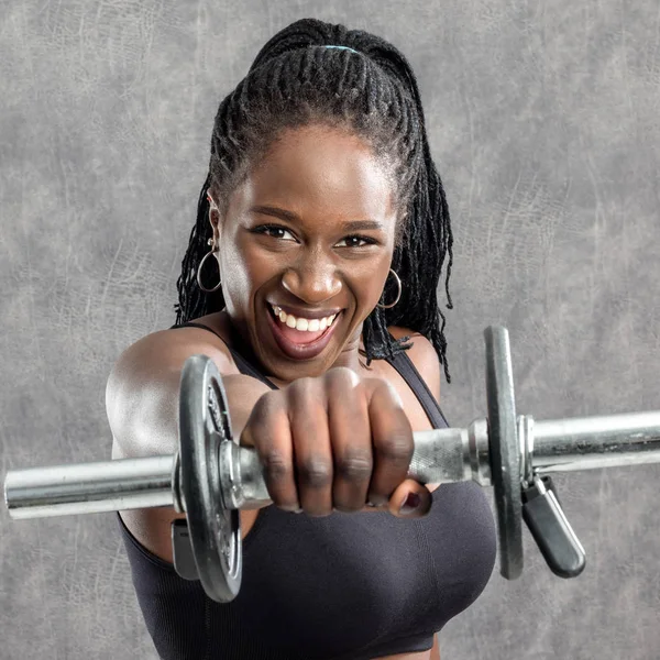 African girl shouting with dumbbells — Stock Photo, Image