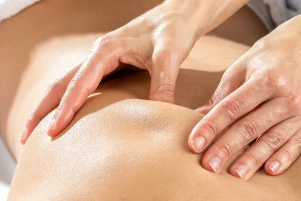 Hands massaging shoulder blade — Stock Photo, Image