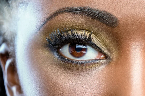 Macro close up of african eye with make up. — Stock Photo, Image