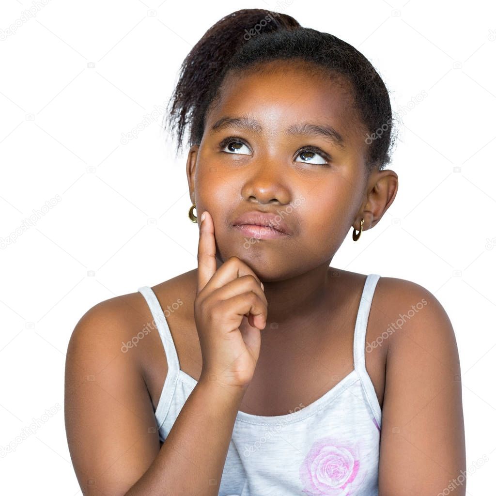 Cute African girl looking up with finger on cheek.