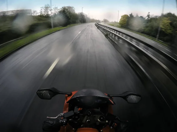 Motorcycle in motion - a view from rider position in rain