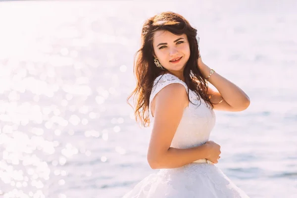 Elegante joven con un hermoso vestido en el océano — Foto de Stock