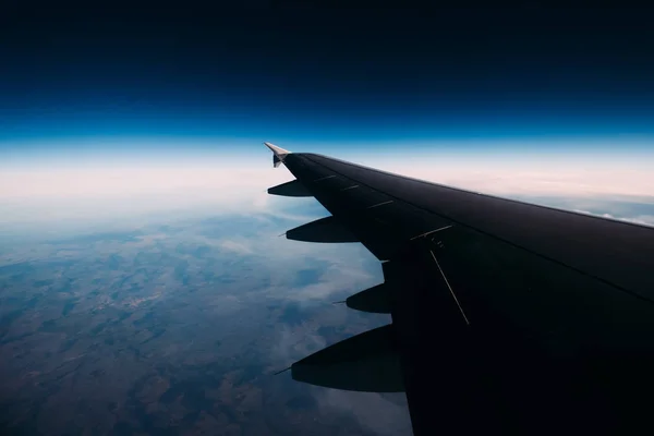 Abstract view of a wing of the aircraft in the space above the s — Stock Photo, Image