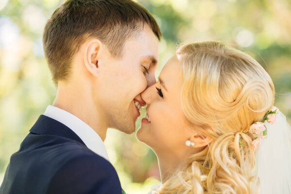 Closeup of beautiful happy couple kissing in the park