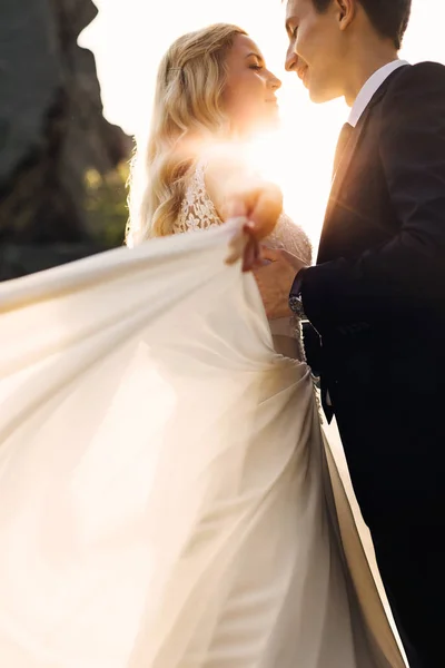 Natural portrait of bride and groom dancing in sunlights — Stock Photo, Image