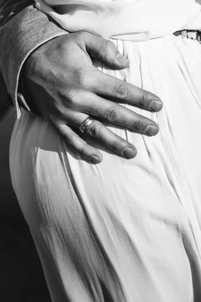 Man's hand with engagement ring closeup hugging woman's waist ge — Stock Photo, Image