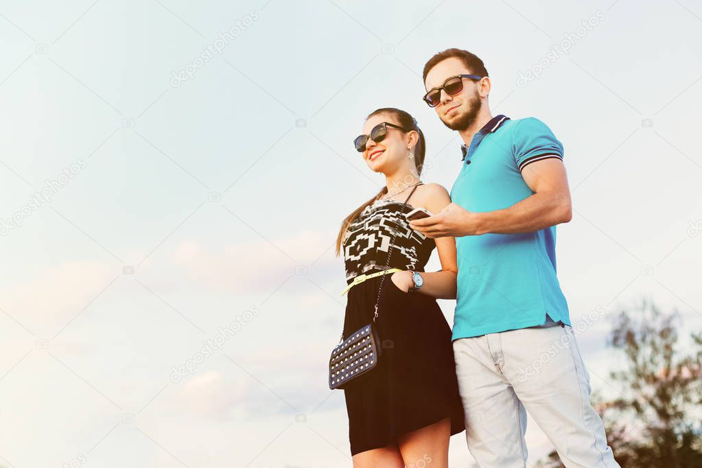 Stylish couple standing together smiling happily. Man in blue po