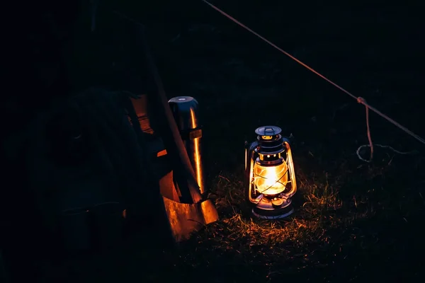 Old oil kerosene metal lantern lighting on the night on camping — Stock Photo, Image